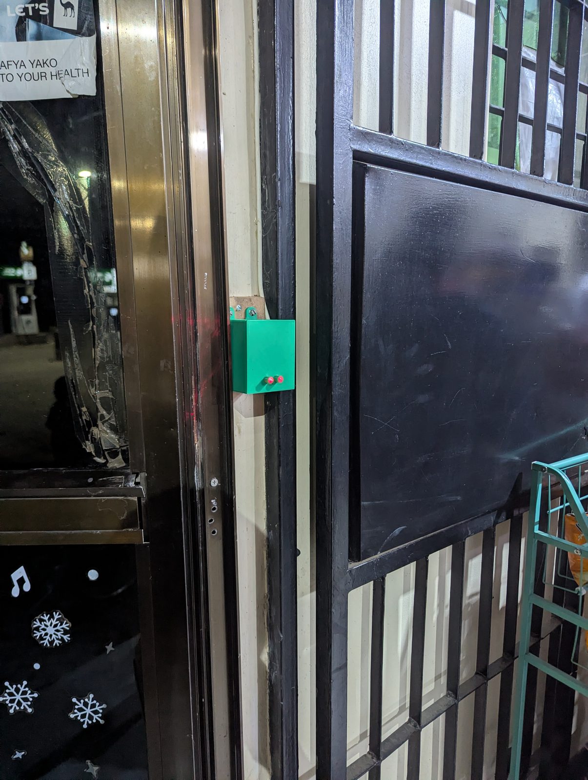 The transmitter unit mounted on the opposite side of the doorway